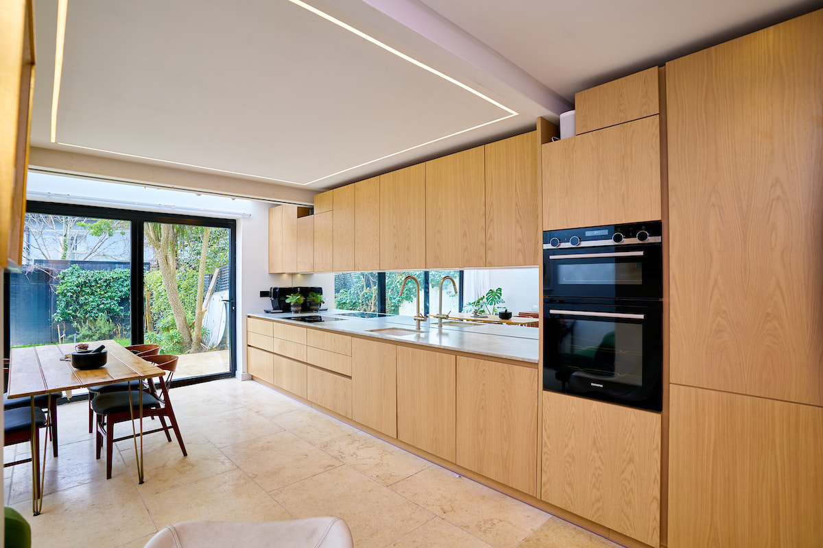 Example of a Japandi style kitchen, contemporary design with sleek, light wood units