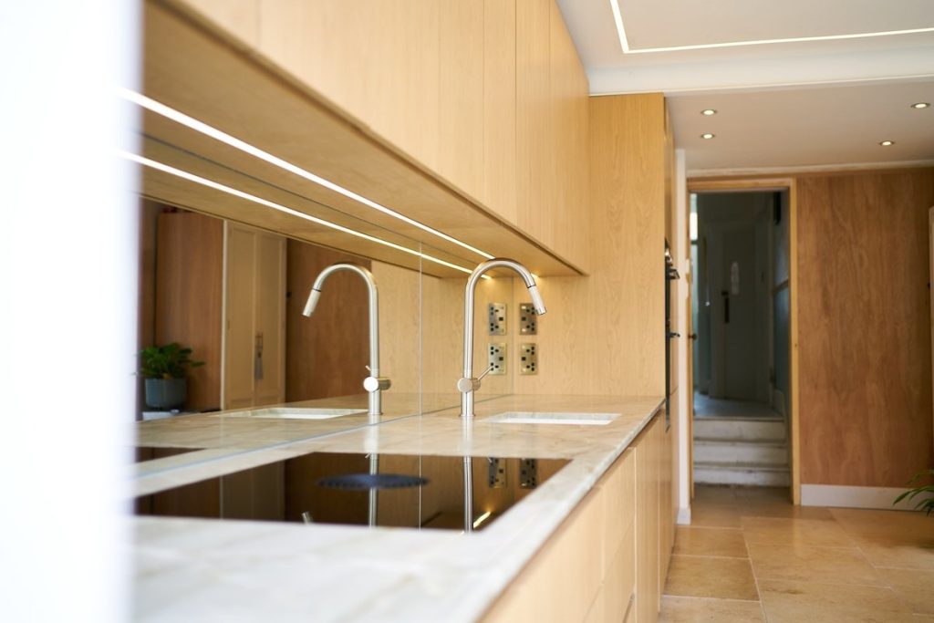 Kitchen led strip lighting beneath oak wall cabinets