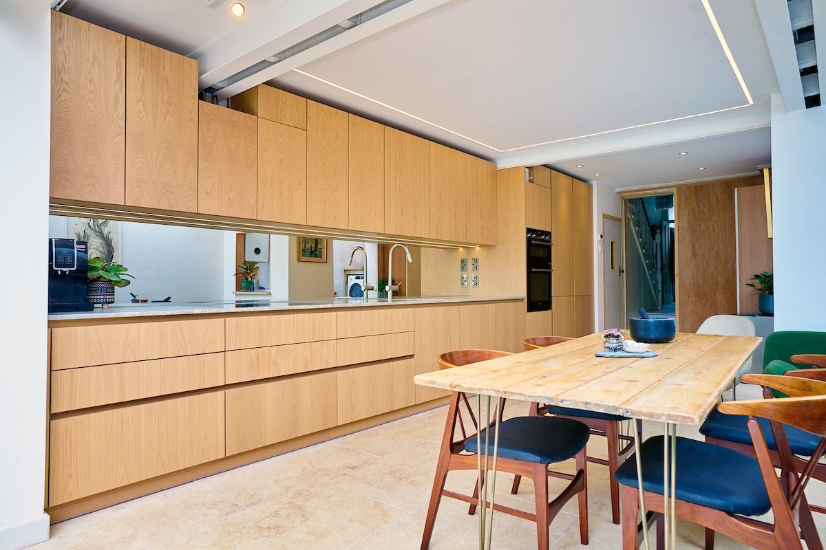 Sleek handless contemporary Skandi style bespoke oak kitchen design
