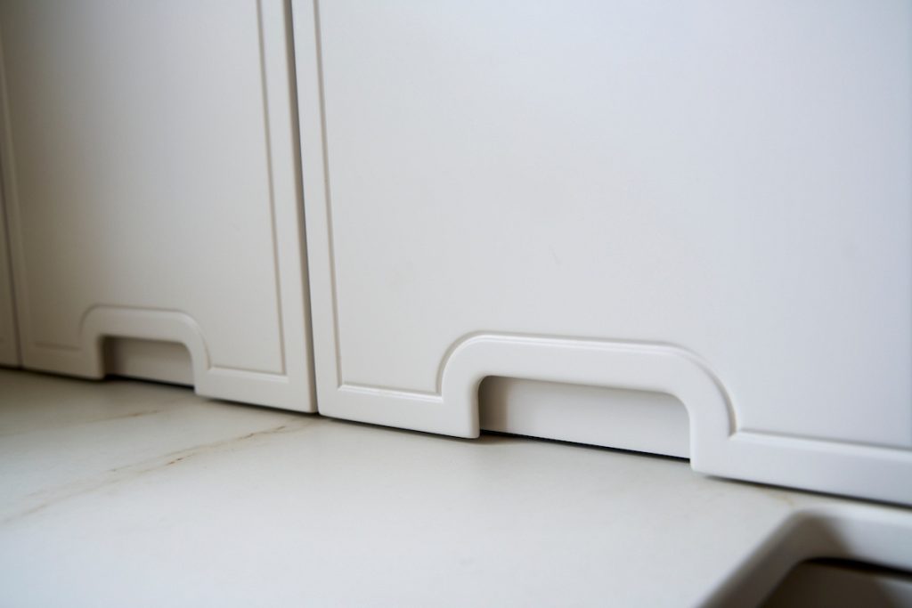 Dog-friendly modern kitchen with patio access and calming neutral tones, designed for family living.